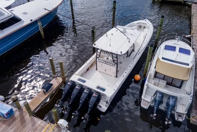  Yacht Photos Pics 2020 Contender 44 ST boat docked with triple outboard engines.