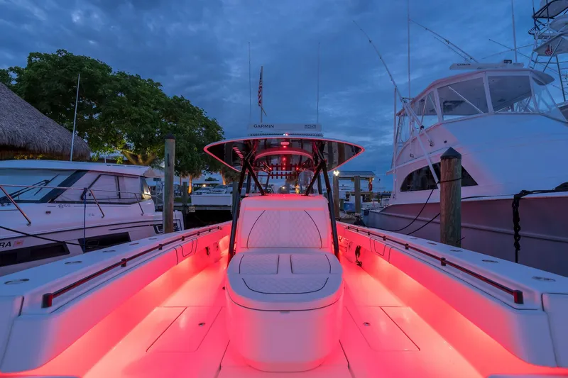  Yacht Photos Pics 2020 Contender 44 ST boat with vibrant red deck lighting at marina.
