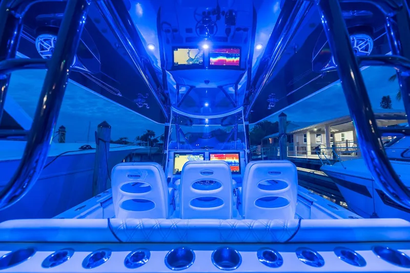  Yacht Photos Pics 2020 Contender 44 ST boat interior with blue LED lighting and advanced navigation displays.