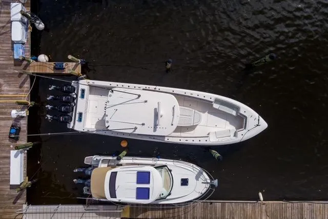  Yacht Photos Pics Aerial view of 2020 Contender 44 ST boat docked beside another vessel.
