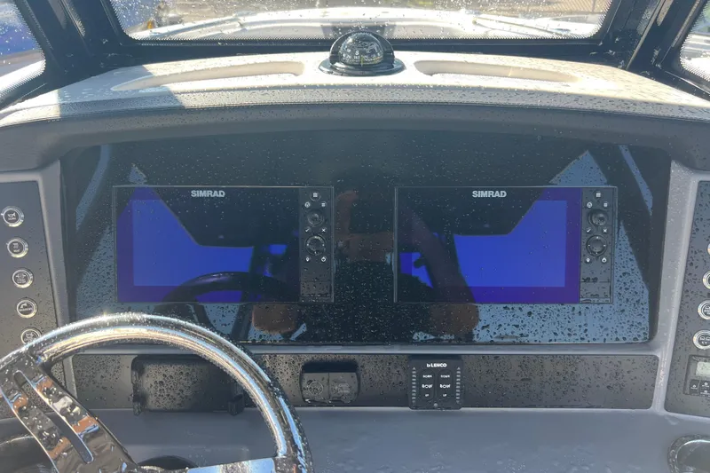  Yacht Photos Pics 2025 Robalo R270 Center Console dashboard with dual Simrad displays and steering wheel.