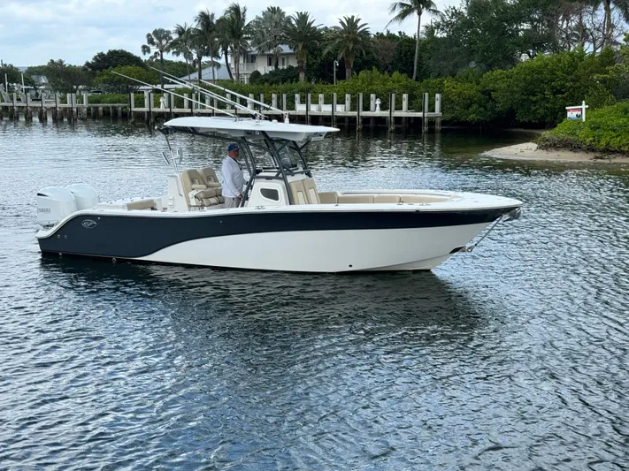  Yacht Photos Pics 2017 Sea Fox 288 Commander boat on calm water near lush shoreline.