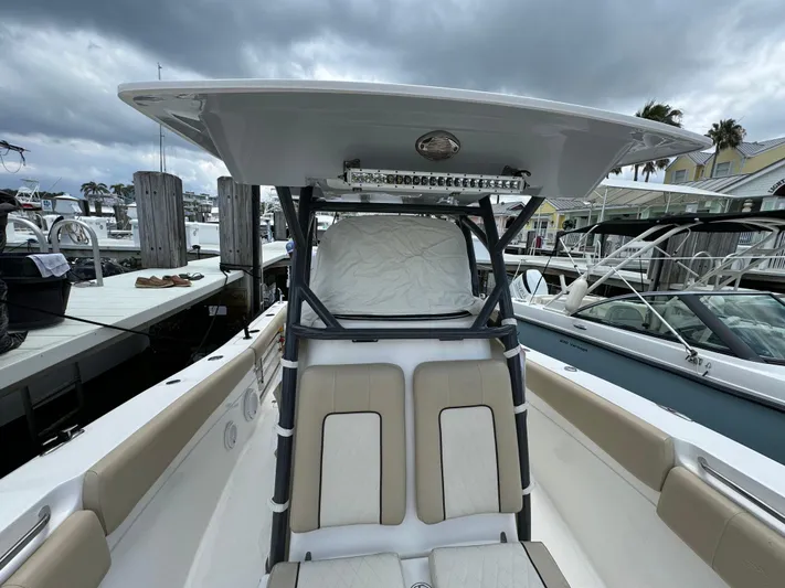  Yacht Photos Pics 2017 Sea Fox 288 Commander boat at marina, featuring cushioned seating and T-top.