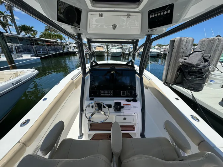  Yacht Photos Pics 2017 Sea Fox 288 Commander boat interior at marina, featuring helm and seating.
