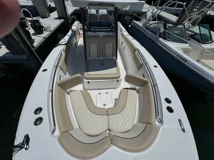  Yacht Photos Pics 2017 Sea Fox 288 Commander boat with spacious seating and sleek design at a marina.