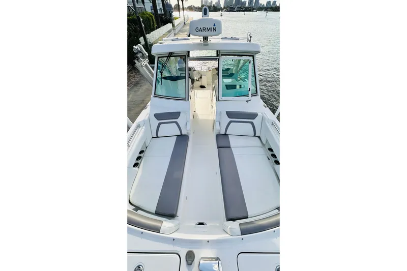  Yacht Photos Pics 2019 World Cat 320 DC boat interior with seating, docked by the water.