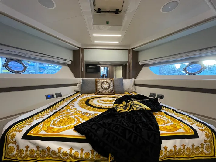  Yacht Photos Pics Luxurious bedroom interior of 2020 Ferretti Yachts 550 with elegant bedding and modern design.