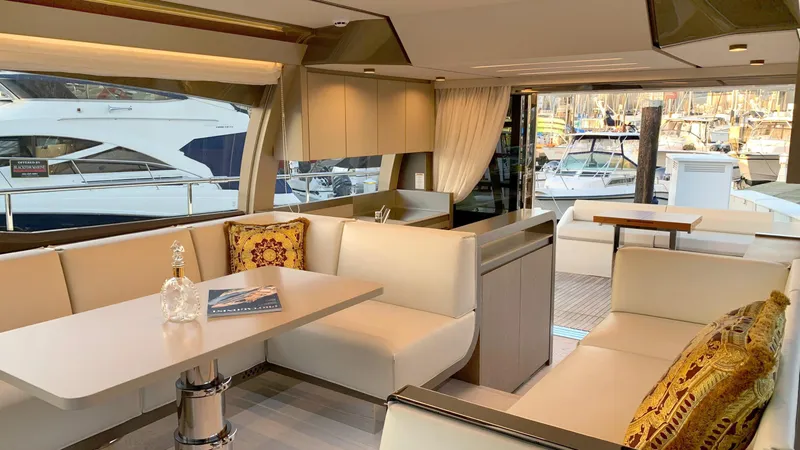  Yacht Photos Pics Luxurious interior of 2020 Ferretti Yachts 550 with elegant seating and marina view.