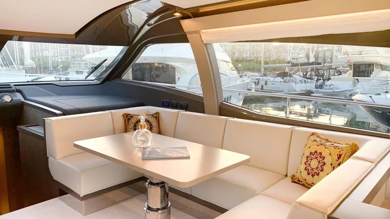  Yacht Photos Pics Luxurious interior of 2020 Ferretti Yachts 550 with elegant seating and marina view.