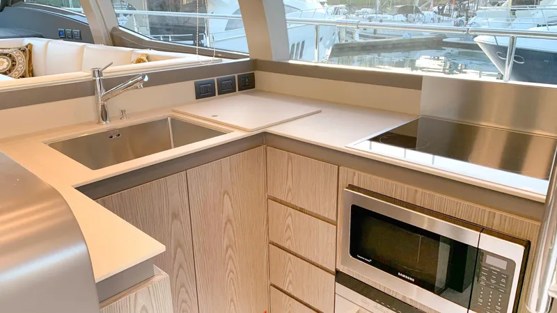  Yacht Photos Pics Modern kitchen in 2020 Ferretti Yachts 550, featuring sleek appliances and wood cabinetry.