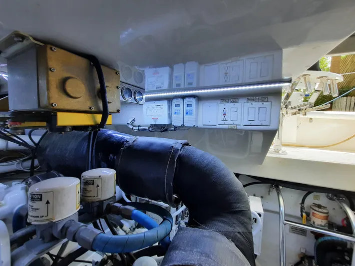 Foam O Yacht Photos Pics Engine room of 2000 Cabo 45 Express with control panels and pipes.