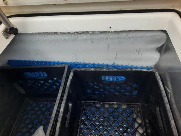 Foam O Yacht Photos Pics Freezer compartment with black crates on a Cabo 45 Express boat.