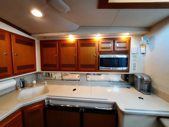 Foam O Yacht Photos Pics Interior of 2000 Cabo 45 Express with modern kitchen.