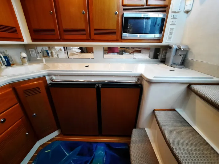 Foam O Yacht Photos Pics Interior of Cabo 45 Express 2000 with kitchen and stairs.