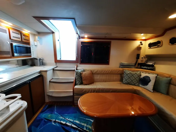 Foam O Yacht Photos Pics Interior of 2000 Cabo 45 Express yacht with cozy sofa and table.