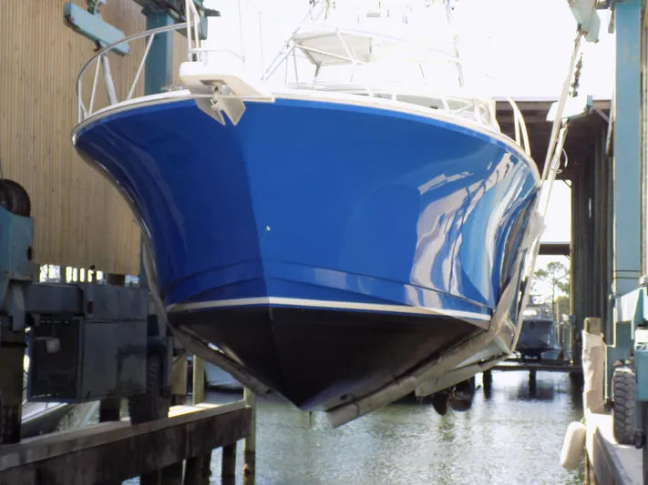 Foam O Yacht Photos Pics Cabo 45 Express 2000 in dry dock, blue hull color.