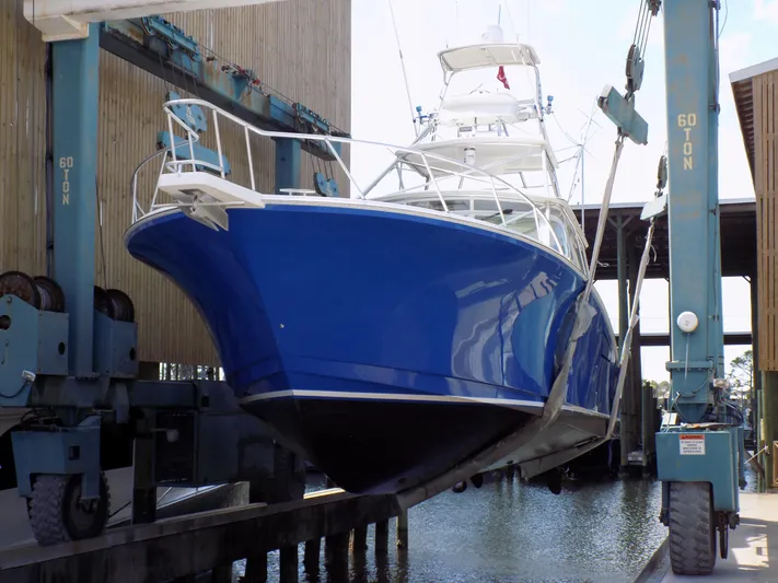 Foam O Yacht Photos Pics Cabo 45 Express 2000 in a shipyard, painted blue.