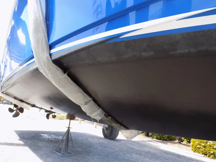 Foam O Yacht Photos Pics Cabo 45 Express 2000 boat hull on stands, painted blue and black.