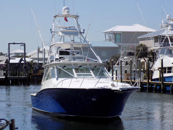 Foam O Yacht Photos Pics Cabo 45 Express 2000 yacht in harbor, blue and white design.