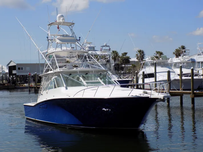 Foam O Yacht Photos Pics Cabo 45 Express 2000 in harbor, blue and white yacht.