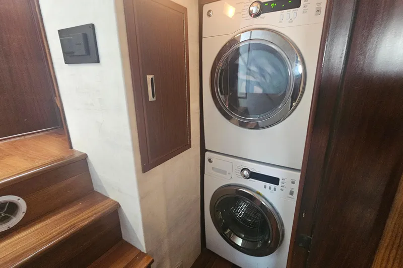 Kokomo Yacht Photos Pics Stacked washer and dryer in 1990 Hatteras 67 Cockpit Motor Yacht interior.