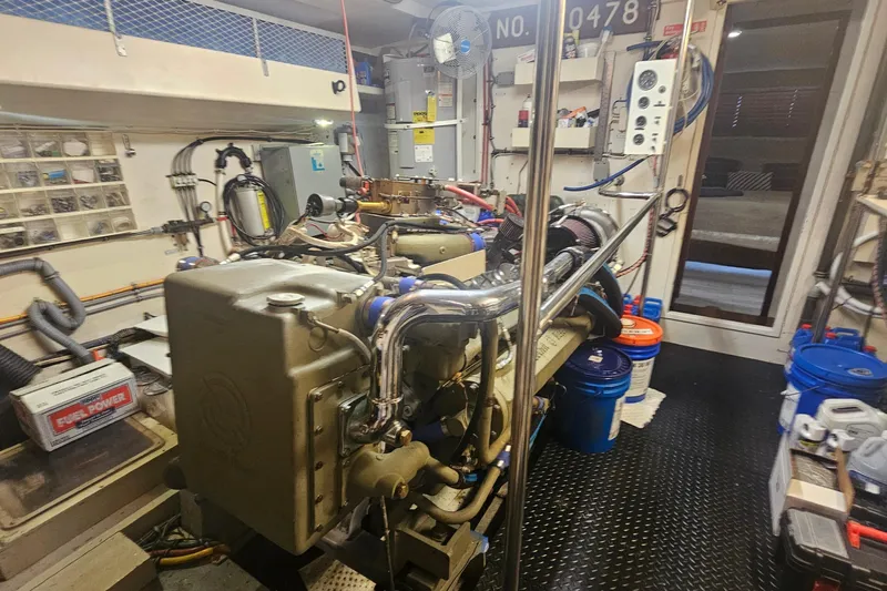 Kokomo Yacht Photos Pics Engine room of 1990 Hatteras 67 Cockpit Motor Yacht with visible machinery and equipment.