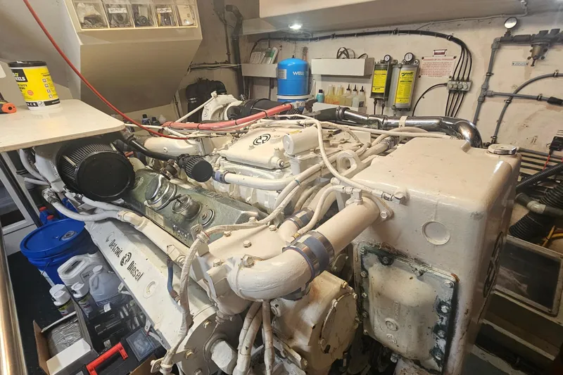Kokomo Yacht Photos Pics Engine room of 1990 Hatteras 67 Cockpit Motor Yacht with diesel engine components.