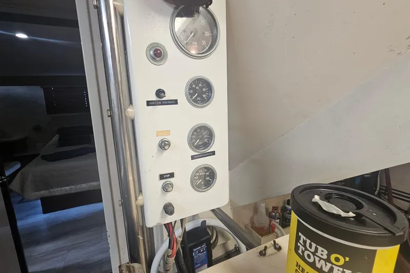 Kokomo Yacht Photos Pics Control panel of a 1990 Hatteras 67 Cockpit Motor Yacht with gauges and switches.