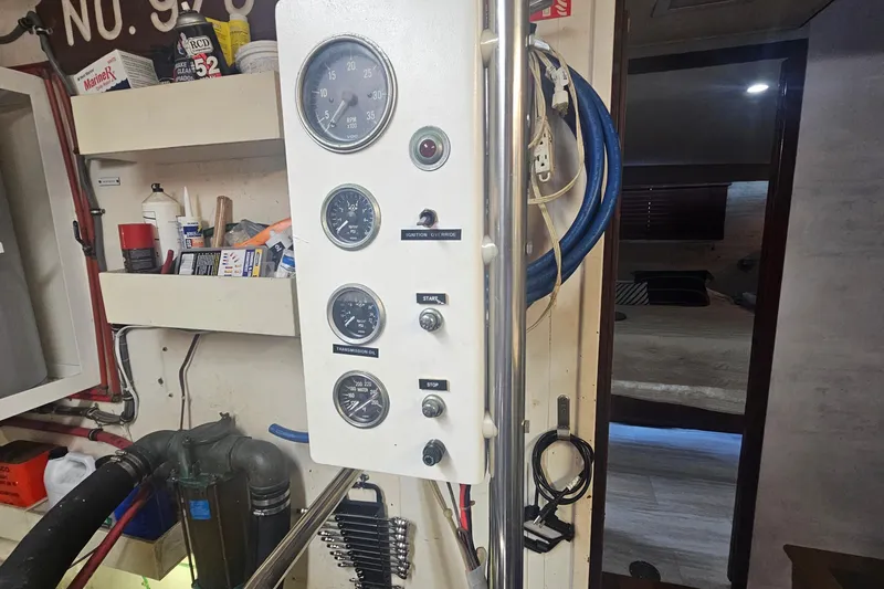 Kokomo Yacht Photos Pics Control panel inside 1990 Hatteras 67 Cockpit Motor Yacht, featuring gauges and switches.