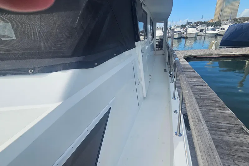 Kokomo Yacht Photos Pics 1990 Hatteras 67 Cockpit Motor Yacht docked at marina, side view.