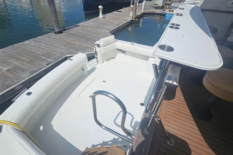 Kokomo Yacht Photos Pics 1990 Hatteras 67 Cockpit Motor Yacht docked, featuring spacious cockpit and sleek design.