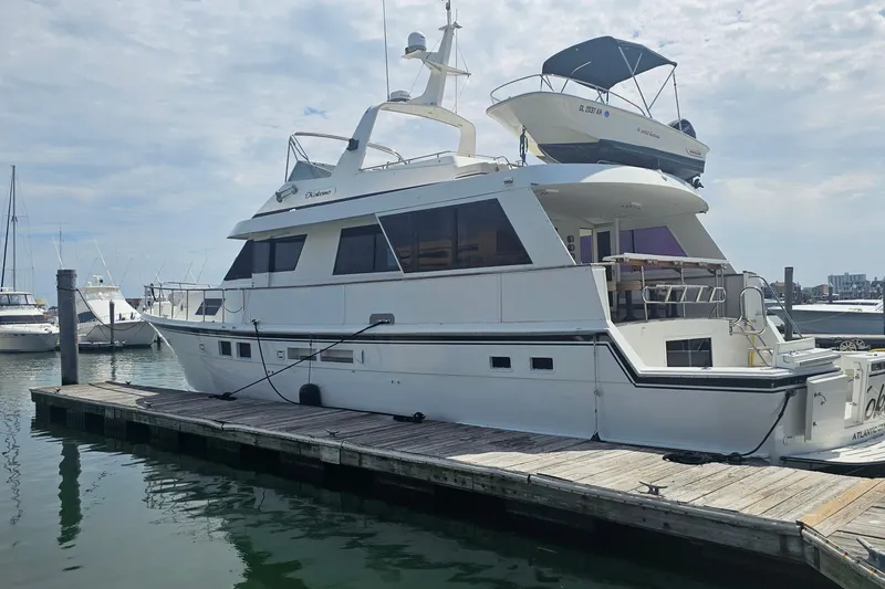 Kokomo Yacht Photos Pics 1990 Hatteras 67 Cockpit Motor Yacht docked at marina under cloudy sky.