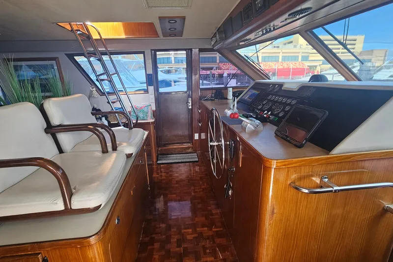 Kokomo Yacht Photos Pics Interior of 1990 Hatteras 67 Cockpit Motor Yacht with helm and seating area.