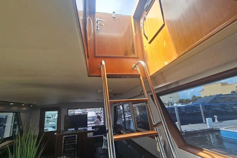 Kokomo Yacht Photos Pics Interior view of 1990 Hatteras 67 Cockpit Motor Yacht with ladder to upper deck.