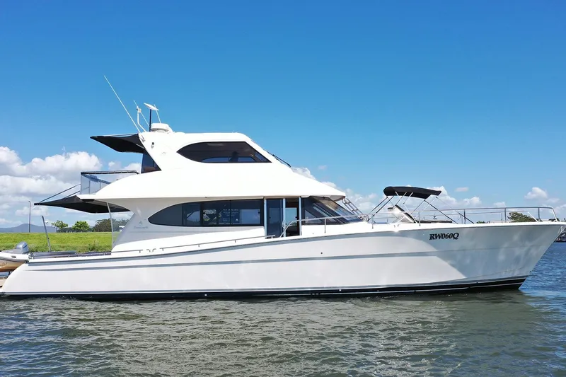 Kahala Yacht Photos Pics 2005 Maritimo M60 yacht on calm water under clear blue sky.