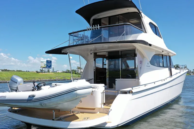 Kahala Yacht Photos Pics 2005 Maritimo M60 yacht with tender, docked on a sunny day.