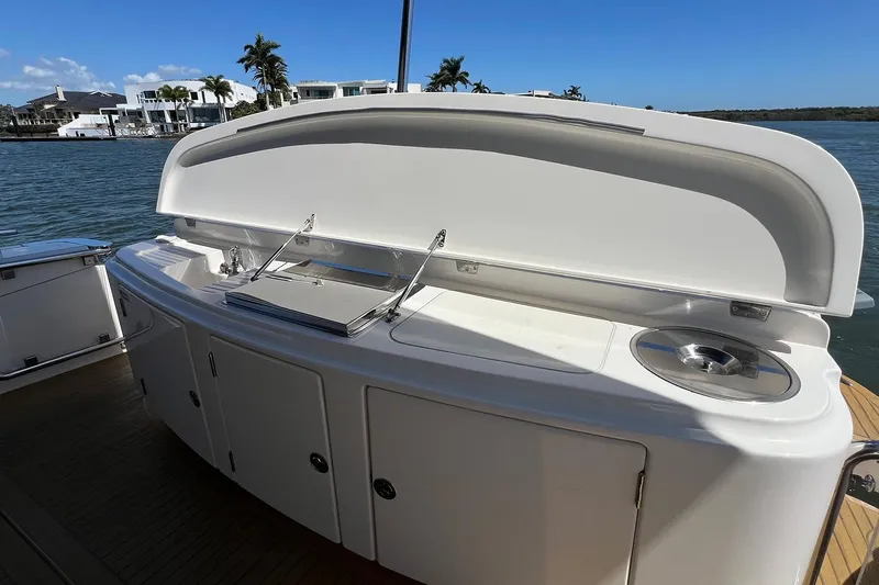 Kahala Yacht Photos Pics Outdoor kitchen on 2005 Maritimo M60 yacht with grill and sink, docked by waterfront homes.