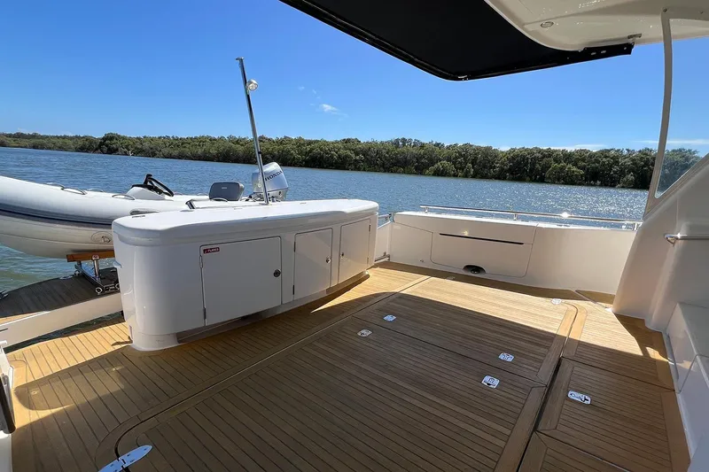 Kahala Yacht Photos Pics 2005 Maritimo M60 yacht deck with scenic river view and inflatable boat.