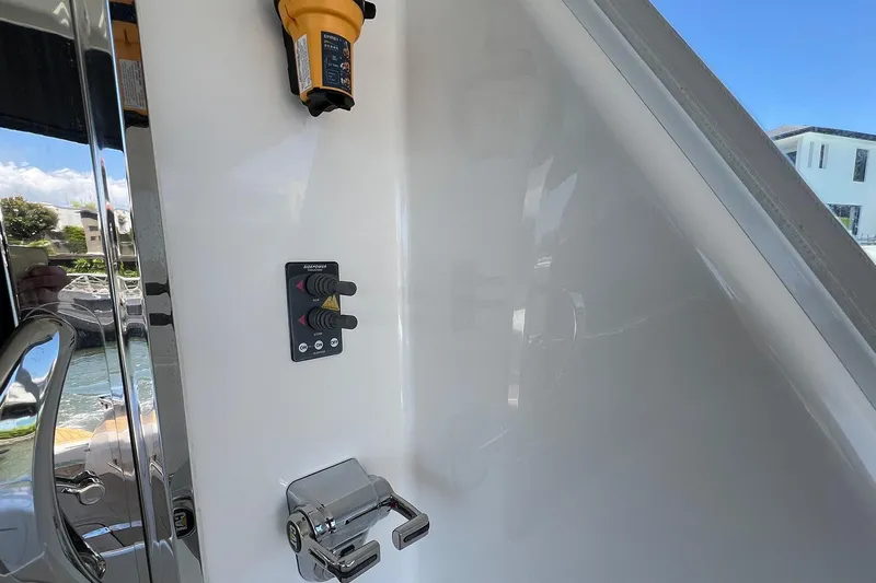 Kahala Yacht Photos Pics Control panel and handle on 2005 Maritimo M60 yacht, with water view in background.