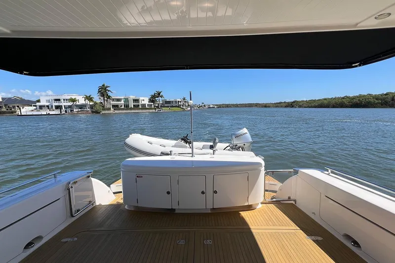 Kahala Yacht Photos Pics 2005 Maritimo M60 yacht deck with scenic waterfront view and inflatable boat.