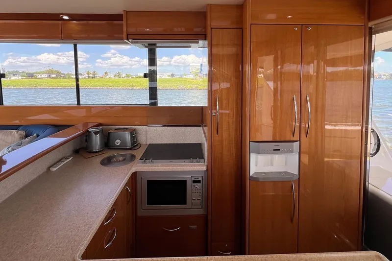 Kahala Yacht Photos Pics Luxurious kitchen interior of 2005 Maritimo M60 yacht with modern appliances and scenic water view.
