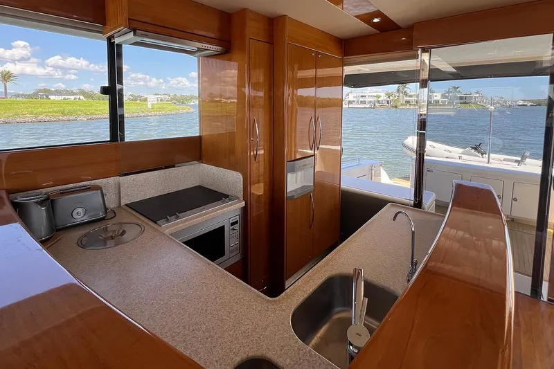 Kahala Yacht Photos Pics Luxurious 2005 Maritimo M60 yacht kitchen with modern appliances and scenic water view.