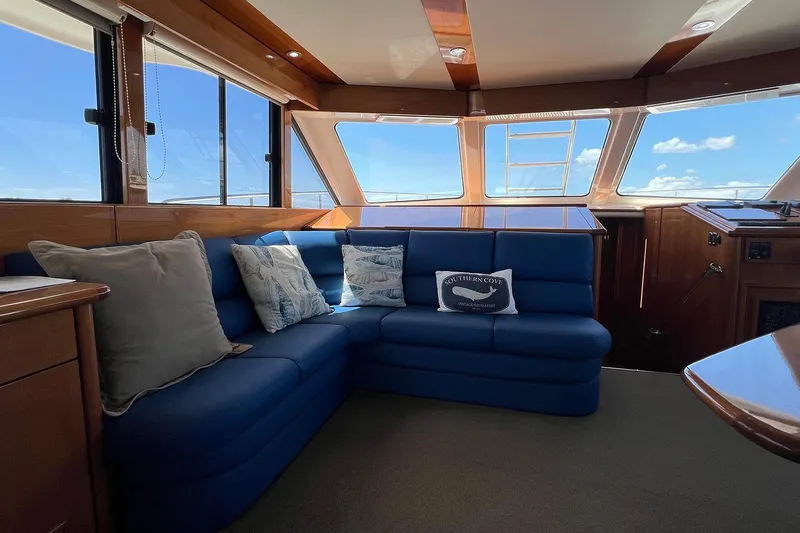Kahala Yacht Photos Pics Luxurious interior of 2005 Maritimo M60 yacht with blue seating and large windows.