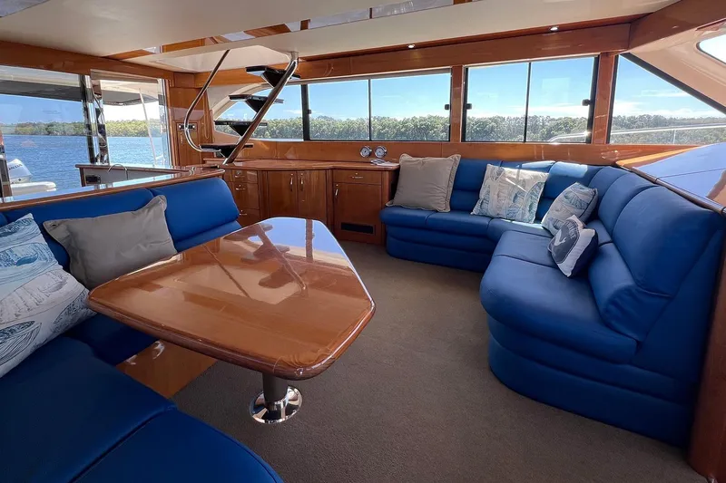 Kahala Yacht Photos Pics Luxurious interior of 2005 Maritimo M60 yacht with blue seating and wooden accents.