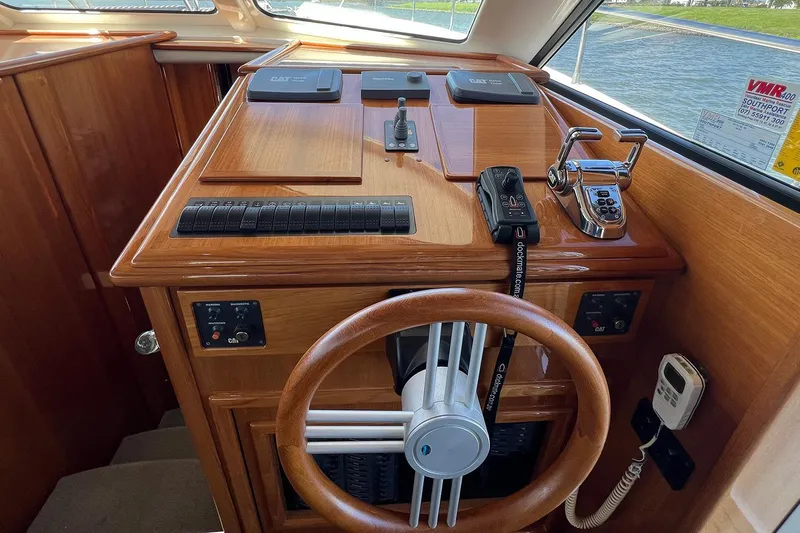 Kahala Yacht Photos Pics 2005 Maritimo M60 yacht helm with wooden steering wheel and control panel.