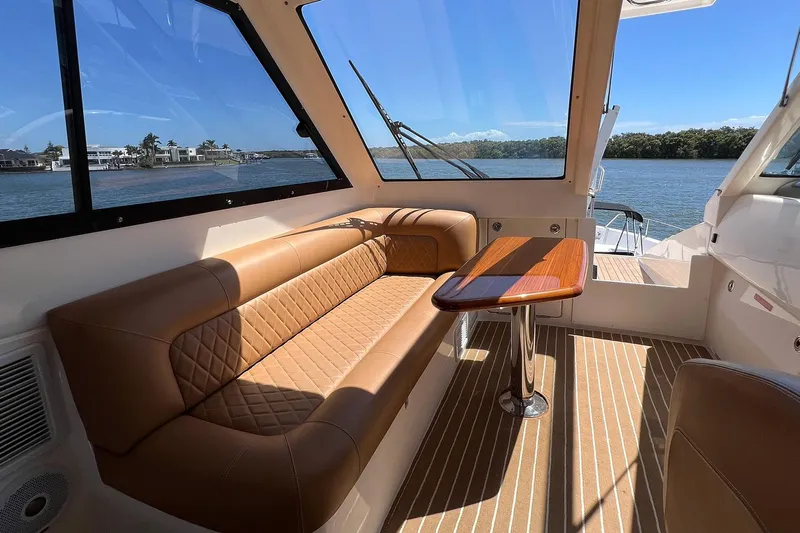 Kahala Yacht Photos Pics Luxurious interior of 2005 Maritimo M60 yacht with leather seating and wooden table.