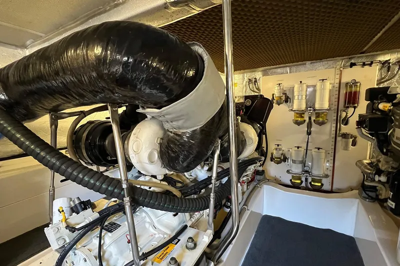 Kahala Yacht Photos Pics Engine room of a 2005 Maritimo M60 yacht, showcasing mechanical components and filters.