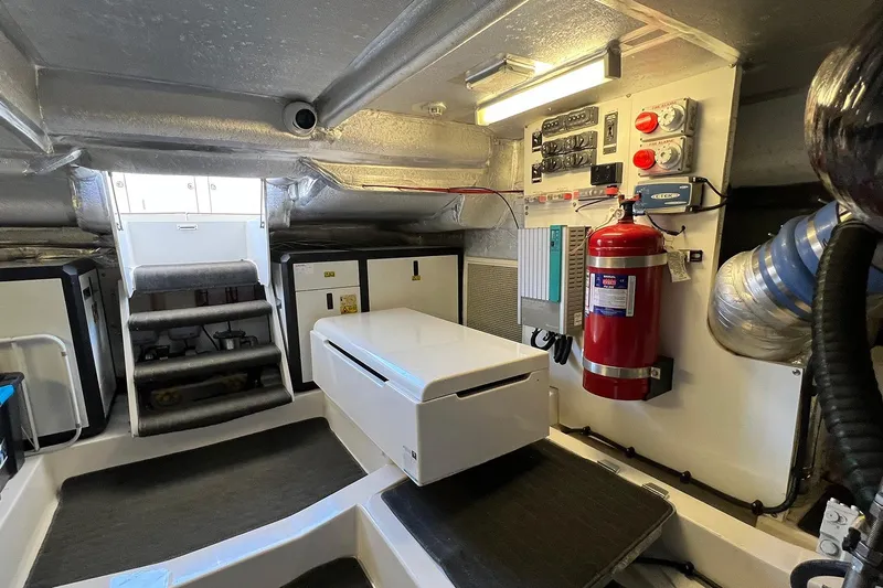 Kahala Yacht Photos Pics 2005 Maritimo M60 engine room with control panels and fire extinguisher.