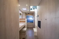 Modern interior of 2016 Leopard 40 yacht with light wood finish and cozy sleeping area.