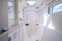 Bathroom interior of 2016 Leopard 40 catamaran, featuring modern fixtures and natural light.